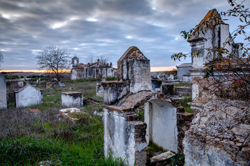 Fototapeta na wymiar Abandoned church ruin and cemetery overgrown landscape
