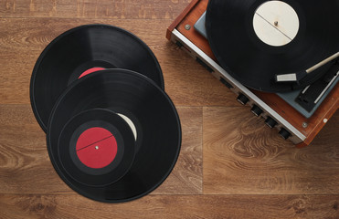 Retro vinyl record player with a records on the floor. 80s. Top view