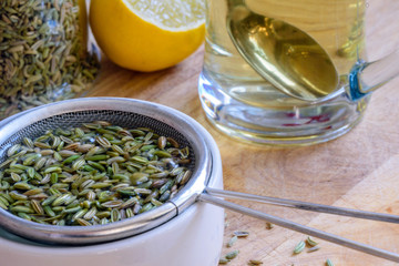 fennel seeds inside sieve being brewed for healthy drink