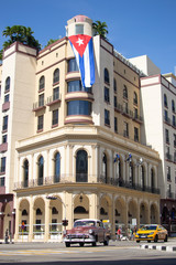 HAVANA,CUBA - MAY 4,2019 : Street scene with classic old cars and traditional colorful buildings in downtown Havana floridita capitolio plaza de la constitucion
