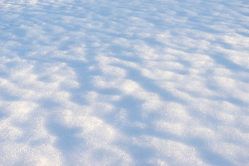 Melted snow with an interesting texture with shadows from bumps