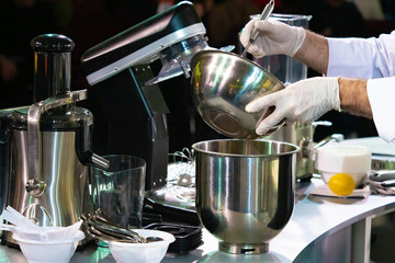 Mixer in the kitchen of the restaurant. Cook prepares a lot of whipping mixer. Using an industrial mixer. The confectioner wants to whip the products. Work as a confectioner. Cooking cakes.