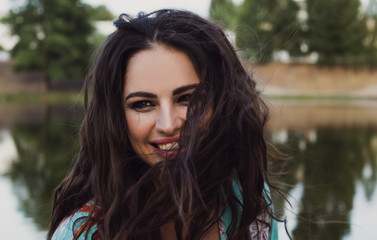 Naklejka premium portrait of a beautiful laughing girl on a background of nature