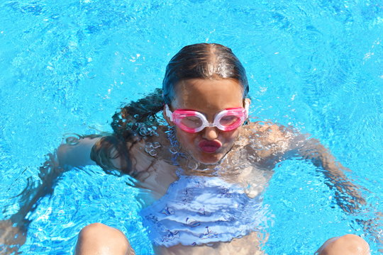 portrait of a girl underwater. The child in the water during the summer. Interesting photo