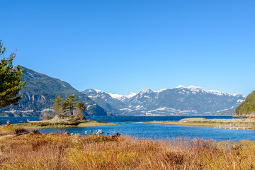 Fantastic view over ocean, snow mountain and rocks at Furry Creek Dive Site in Vancouver, Canada.
