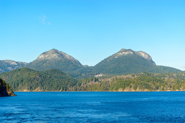 Fantastic view over ocean, snow mountain and rocks at Sechelt inlet in Vancouver, Canada.