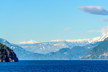 Fantastic view over ocean, snow mountain and rocks at Sechelt inlet in Vancouver, Canada.