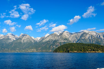 Fantastic view over ocean, snow mountain and rocks at Sechelt inlet in Vancouver, Canada.