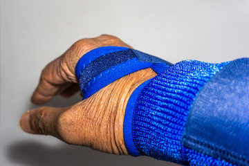 Blue hand strap on injured hand or twisted wrist 