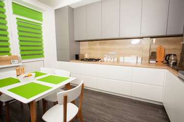 Moden white and greuy interior with green accessories for kitchen.