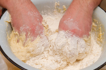 Cooking dough in a white plastic bowl at home