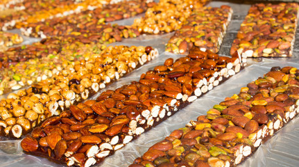 Walnut, almond and Pistachio nut bars on the table, Mediterranean sweets.