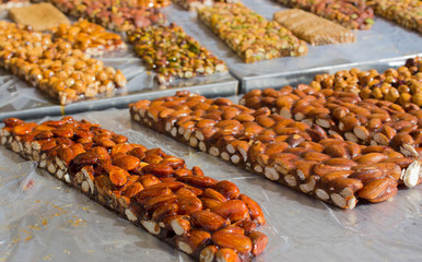 Walnut, almond and Pistachio nut bars on the table, Mediterranean sweets.