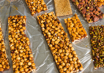 Walnut, almond and Pistachio nut bars on the table, Mediterranean sweets.