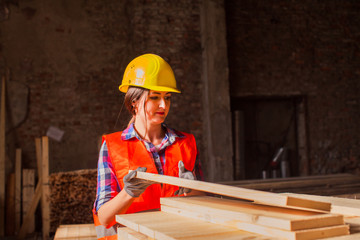 Woman worker sorting wood at production factory. Gender equality concept.