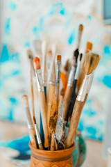 Tools and equipment for the artist. Palette and brushes close-up. The process of drawing and...