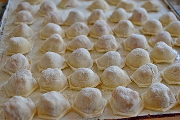 Fresh cooked meat dumplings on a baking sheet
