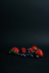 a pile of berries isolated on black background
