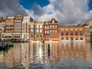 Amsterdam City Canal view with cloudy sky background