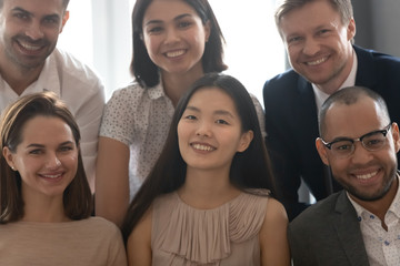 Close up portrait of diverse colleagues smile look at camera