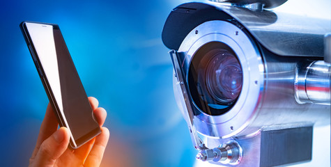 Data transfer from a video surveillance camera to a mobile phone. Modern video surveillance system. Camera and smartphone on a blue background. Ensuring security in the house.