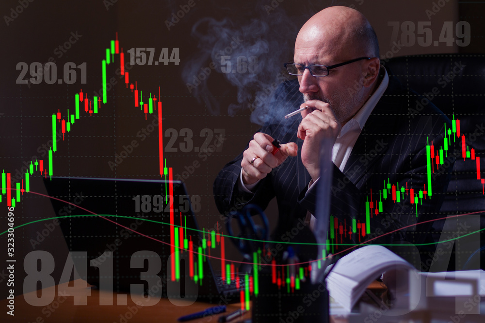 Poster a man smokes a cigarette and stares intently at the computer screen against the background of the dy