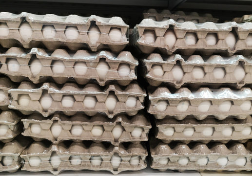 Boxes With Brown Eggs Wrapped In Cling Film With Lots On A Shelf In A Large Grocery Supermarket