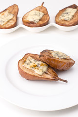 baked pears with honey and cheese on a white plate