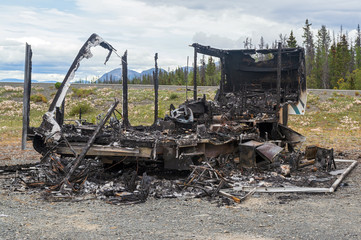 Fototapeta premium The rear of a burned out trailer by the side of the road