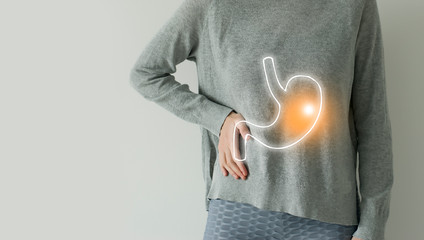 Woman in casual grey clothes suffering from indigestion pain, highlighted vector visualisation of stomach - obrazy, fototapety, plakaty