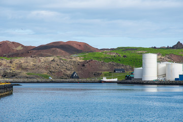 Obraz premium Fish oil tanks and historic buildings in Vestmannaeyjar Iceland