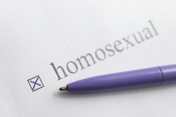 Homosexual- checkbox with a tick on white paper with pen. Checklist concept.