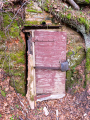 fragments of wooden doors in the sandstone wall