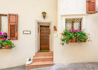 Fototapeta premium Picturesque small town street view in Limone, Lake Garda Italy. Entrance of an apartment or house.