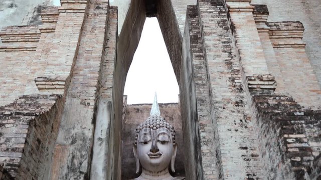 Sculpture sitting buddha image of Wat Tra Phang Thong Lang in the National Park of Sukhothai in Thailand. Travel to Asia , holidays concept. Buddhist religion, ancient art and asian heritage culture.
