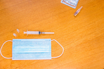 Medical mask with ear straps on white background. Medical tools health professionals.Disposable syringes