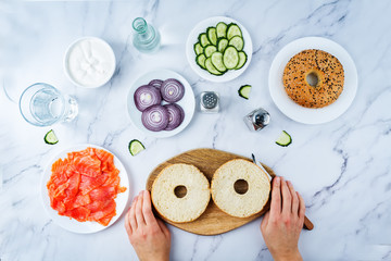 Marble table with ingredients for making bagel or sandwich for lunch