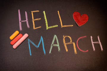 Hello march concept on chalkboard with colorful chalk and wooden heart replace the letter o