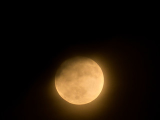 Full moon behind the clouds