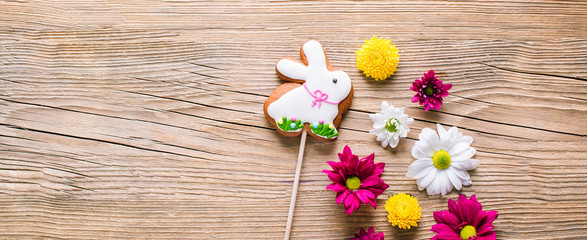 Easter cookies on wooden background, gingerbread in the shape of a rabbit