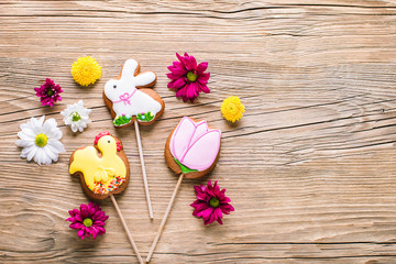 Easter cookies, gingerbread in the shape of a rabbit and chicken, spring Easter background with flowers
