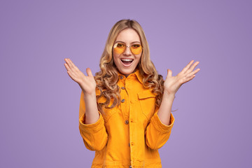 Excited young woman screaming and gesticulating