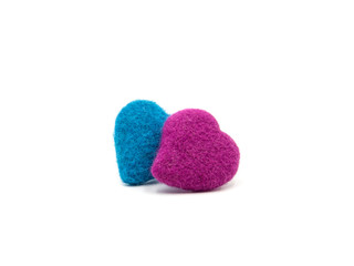 Obraz premium A pile of pink and blue crochet heart on white background. Felting wool