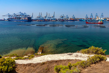 A large container ship is loaded in the cargo port of Malta.