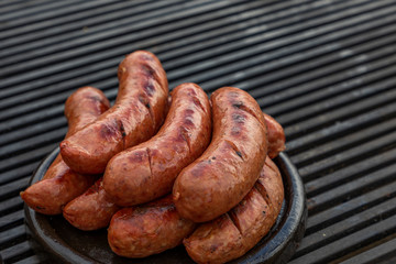 Pork sausage and hot dogs on the grill