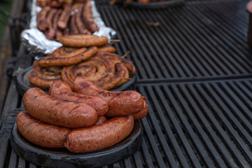Pork sausage and hot dogs on the grill