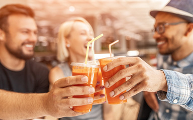 Cheerful friends toasting with carrot juice - obrazy, fototapety, plakaty
