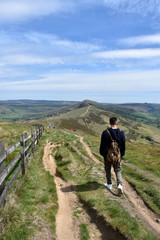 Obraz premium A man hiking in a mountain in a green and natural landscape