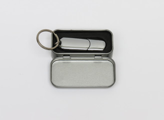 USB memory stick as a present in a metal gift box. Silver usb flash drive, flash card isolated on white background. Usb flash drive.