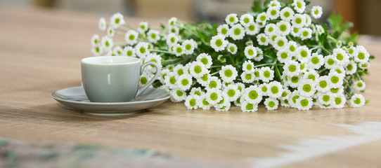 Fresh italian style coffee next to flower bouquet